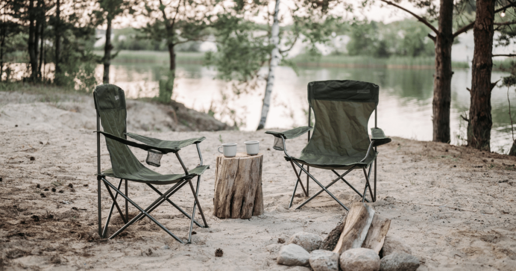 THISI IS AN IMAGE OF TWO CAMP CHAIRS BY A RIVER