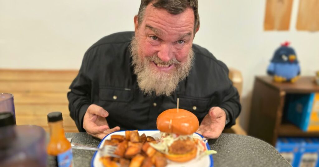 Blue Hen Cafe: St. Augustine’s Best Breakfast Spot THIS IS AN IMAGE OF A MAN SMILING WITH THE BAJA FISH SANDWICH