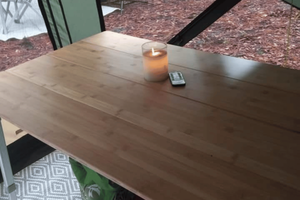 table in tent with candle
