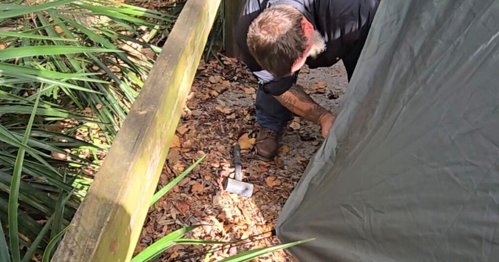 THIS IS AN IMAGE OF A MAN SETTING UP THE GAZELLE T4 PLUS TENT