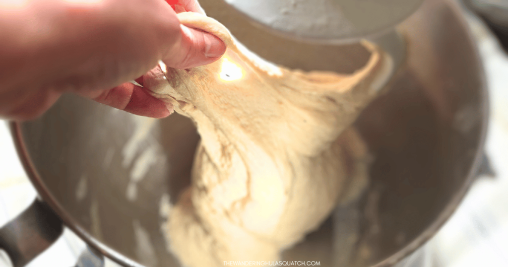bread dough in mixer window pane test