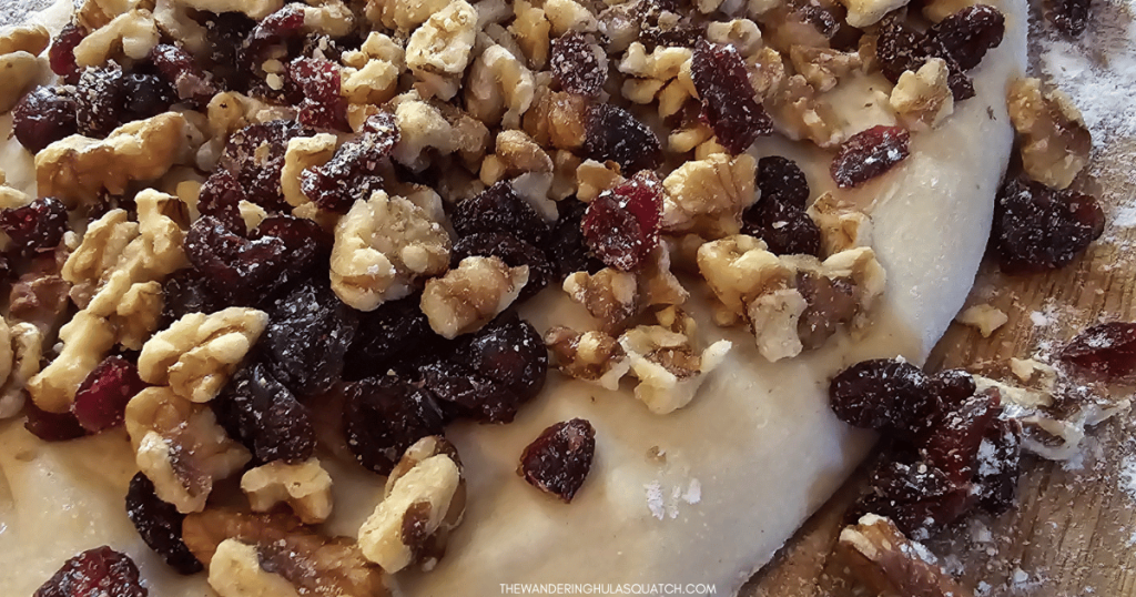 cranberries and walnuts on top of bread dough.