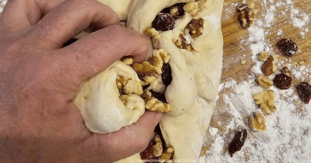 kneading the cranberries and walnuts in bread dough