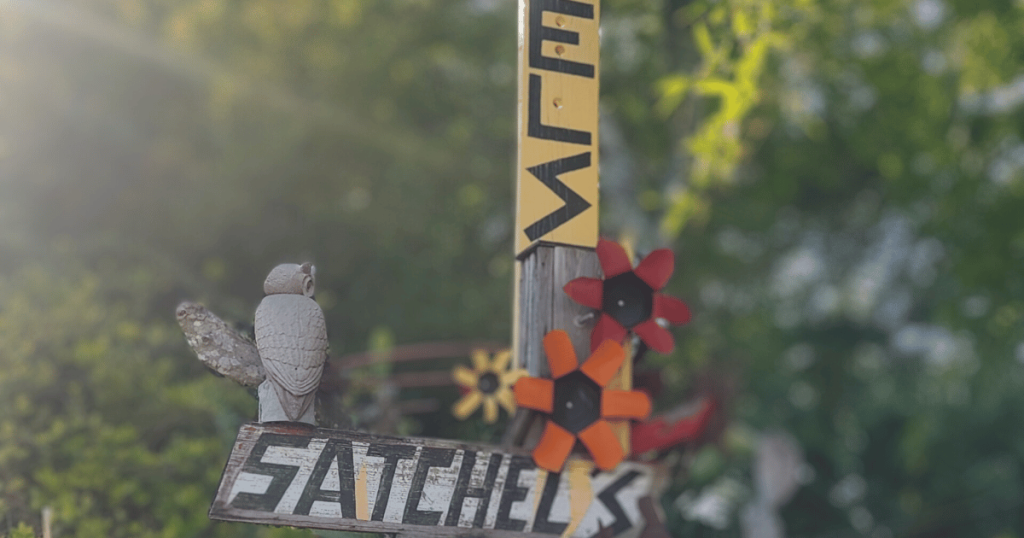 SIGN AT SATCHEL'S PIZZA THAT SAYS SATCHEL'S MADE OF TRASH