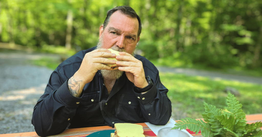 EASY CAMPING MEALS: SIMPLE CAPSULE MEAL PLANNING man eating a sandwich