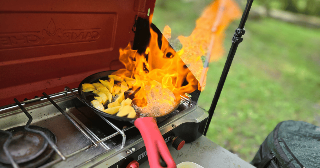 EASY CAMPING MEALS: SIMPLE CAPSULE MEAL PLANNING cast iron skillet on fire on camp stove