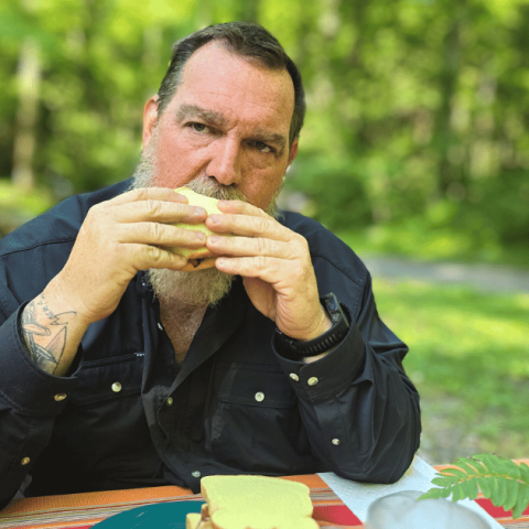 Easy capsule meals to make camp cooking a breeze MAN EATING AT A PICNIC TABLE