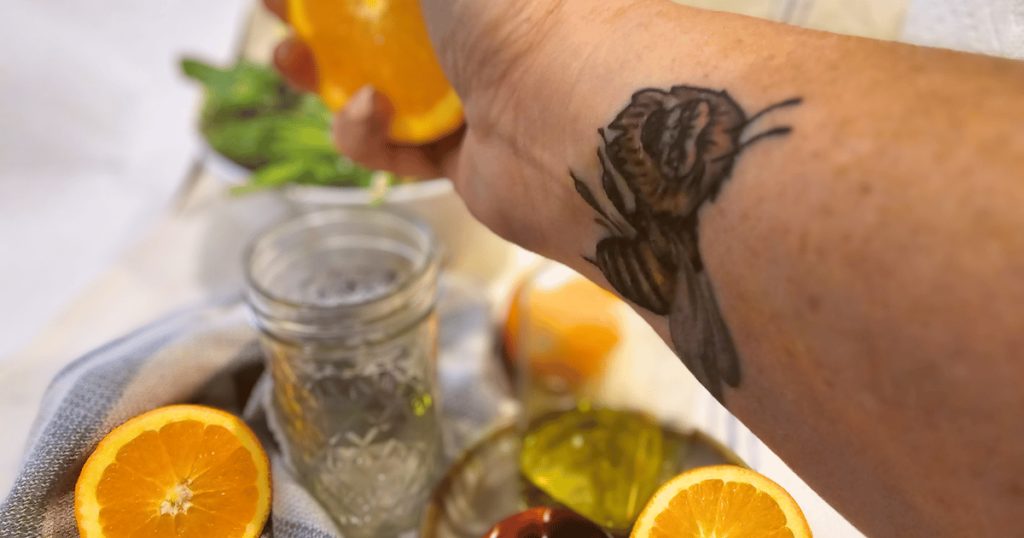 squeezing an orange for vinaigrette