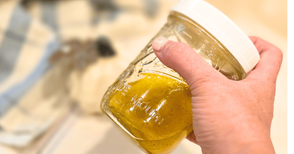 shaking Florida Sunshine vinaigrette in a mason jar