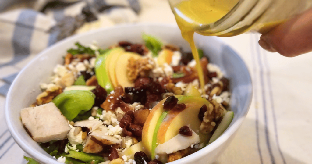FLORIDA FALL HARVEST SALAD pouring dressing on salad