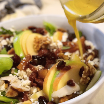 FLORIDA FALL HARVEST SALAD pouring dressing on salad