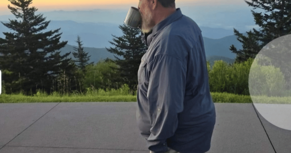 MAN DRINKING COFFEE WATCHING SUNRISE
