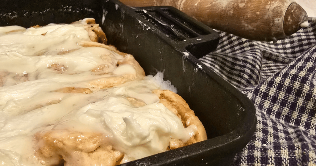 DECADENT HOMEMADE SOUR CREAM CINNAMON ROLLS RECIPE iced cinnamon rolls in a pan