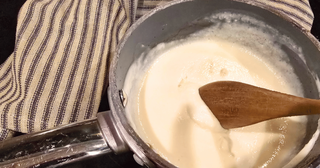 DECADENT HOMEMADE SOUR CREAM CINNAMON ROLLS RECIPE pot with liquid ingredients