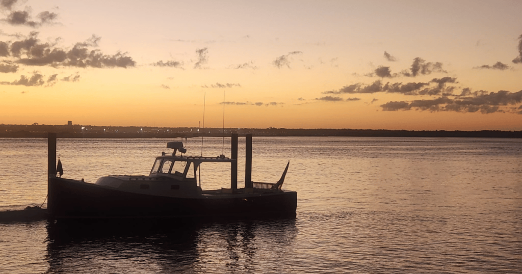 FALL OUTDOORS IN FLORIDA: GUIDE TO AUTUMN ADVENTURES sunset at beach with sailboat