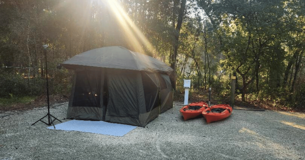 FALL OUTDOORS IN FLORIDA: GUIDE TO AUTUMN ADVENTURES tent with kayaks and morning sunbeam