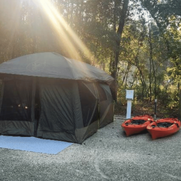 FALL OUTDOORS IN FLORIDA: GUIDE TO AUTUMN ADVENTURES tent with kayaks and a morning sunbeam