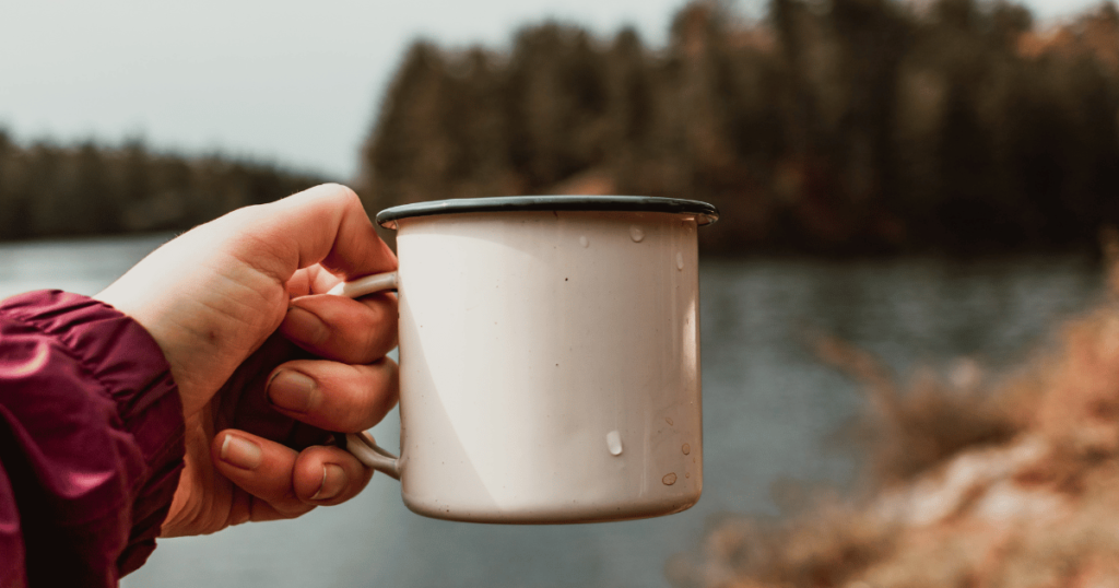 outdoor camping person holding a cup
