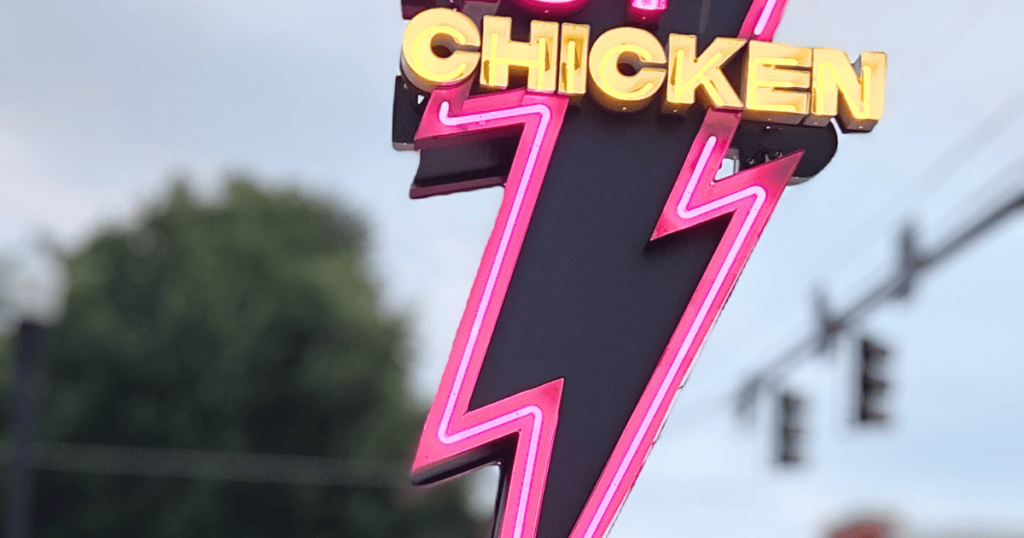LOVEBIRD ALMOST FAMOUS CHICKEN CENTRAL FLORIDA HIDDEN GEM neon lightening bolt street sign