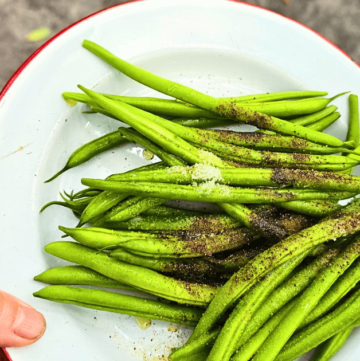 QUICK & EASY CAMPING SIDE DISH IDEAS FOR OUTDOOR ADVENTURES green beans on a white plate