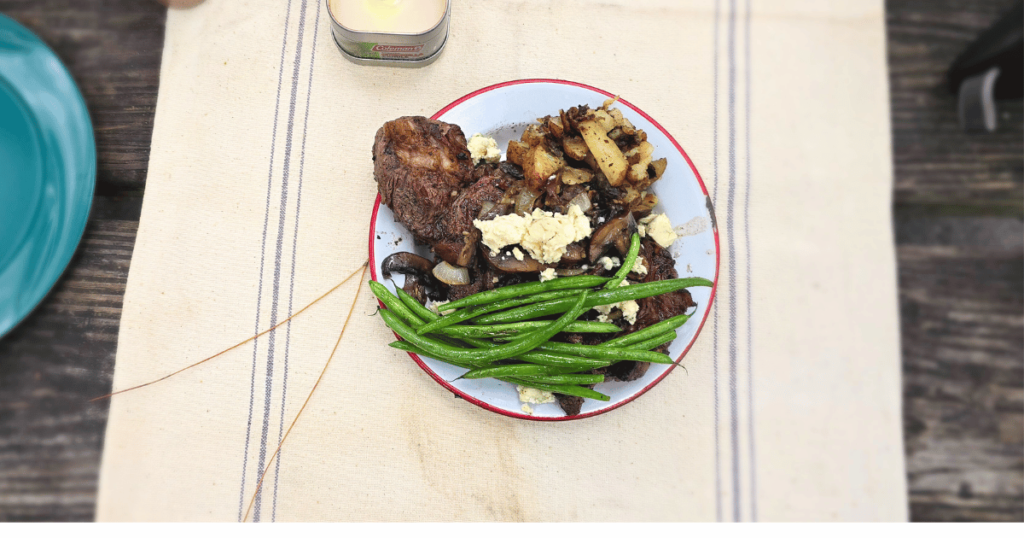 QUICK & EASY CAMPING SIDE DISH IDEAS FOR OUTDOOR ADVENTURES plate with green beans and steak