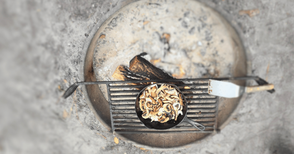 QUICK & EASY CAMPING SIDE DISH IDEAS FOR OUTDOOR ADVENTURES mushrooms in a skillet on the campfire