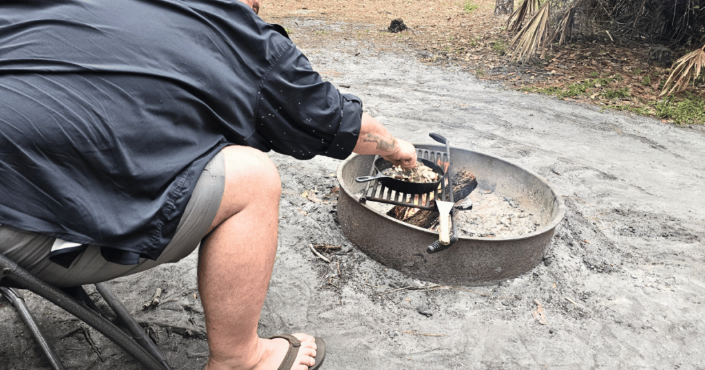 QUICK & EASY CAMPING SIDE DISH IDEAS FOR OUTDOOR ADVENTURES man cooking on campfire