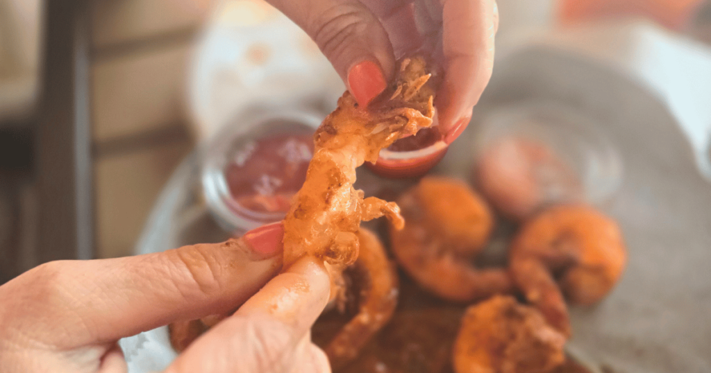 DIVE INTO CRUMPS' LANDING IN HOMOSASSA, FLORIDA this is an image of peeling boiled shrimp.