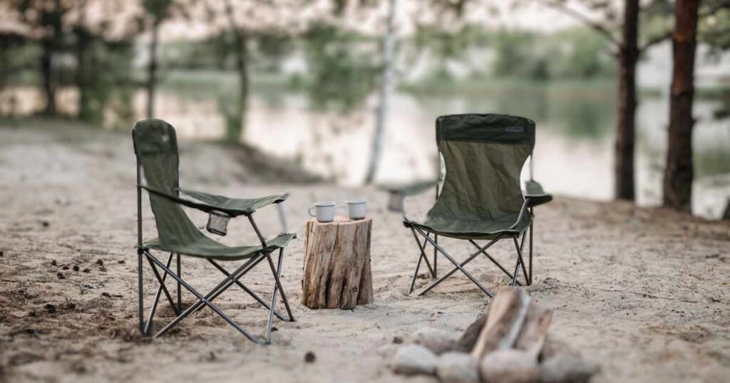 BEGINNERS GUIDE TO CAMPING THIS IS AN IMAGE OF TWO CAMP CHAIRS BY A RIVER