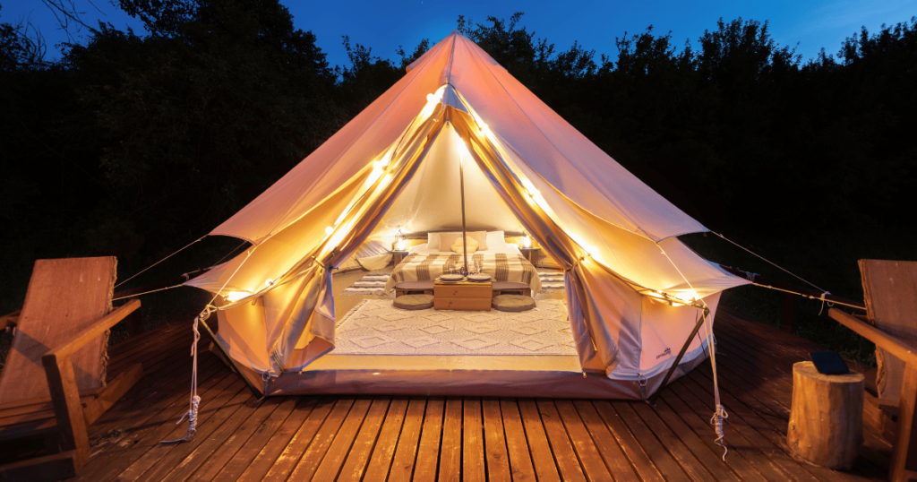 BEGINNERS GUIDE TO CAMPING THIS IS AN IMAGE OF a glamping tent at night