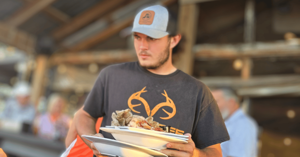 BEST SEAFOOD DIVES IN FLORIDA THIS IS AN IMAGE OF A WAITER AT CAMELLIA STREET GRILLE