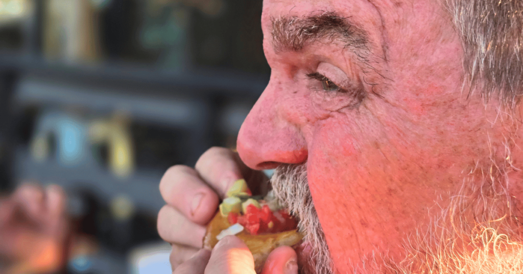 BEST SEAFOOD DIVES IN FLORIDA MAN EATING FRY BREAD AT CAMELLIA STREET GRILLE