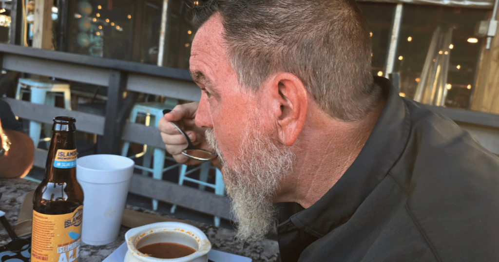 BEST SEAFOOD DIVES IN FLORIDA MAN EATING SHE CRAB SOUP AT CAMELLIA STREET GRILLE