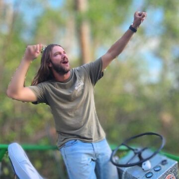 EPIC FLORIDA DAY TRIP EVERGLADES AIRBOAT RIDE AT WOOTEN'S GUY STANDING UP DOING A POSE