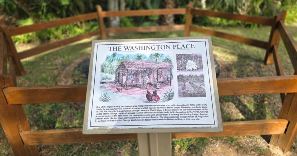 this is an image of a sign depicting a garden cottage at washingto oaks gardens in st. augustine