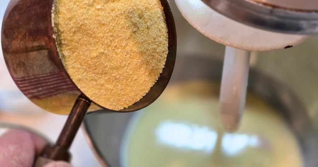 Sweet and Savory Cornmeal Bread adding cornmeal to a stand mixer