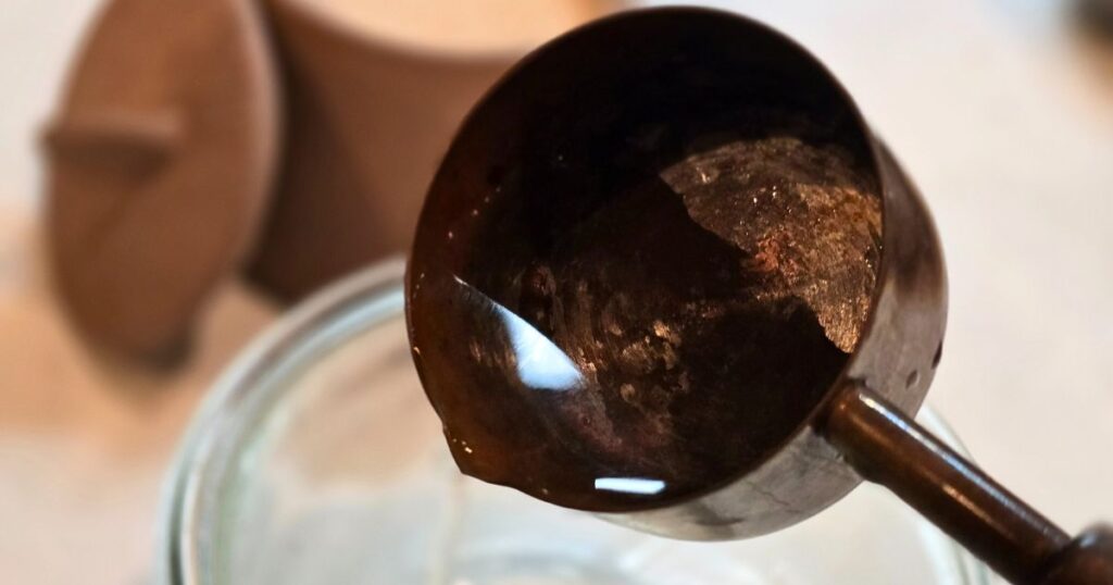 this is an image of pouring water feom a measuring cup