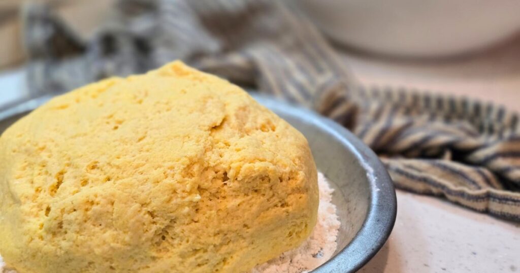 Artisan Honey Cornmeal Bread bread proofing in a pie plate