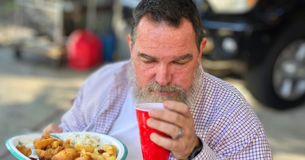 SOUTHERN FISH FRY PARTY IDEAS THIS IS AN IMAGE OF A MAN DRINKING AT A SOUTHERN FISH FRY