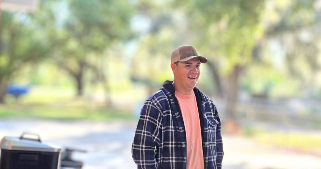 THIS IS AN IMAGE OF A SOUTHERN MAN SMILING AT A FISH FRY