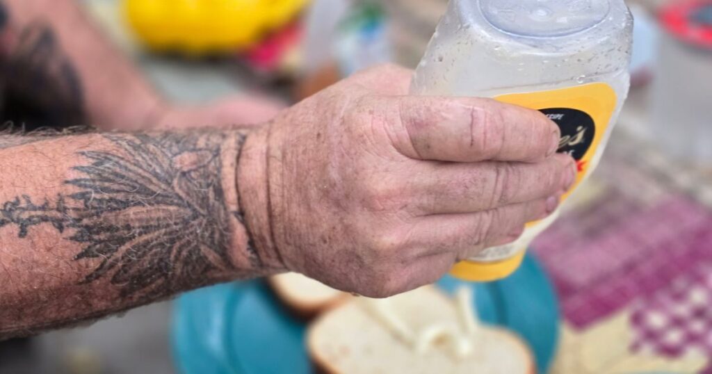 Easy Camping Breakfast Sandwich THIS ISA N IMAGE OF A MAN PUTTING DUKES MAYO ON A BREAKFAST SANDWICH
