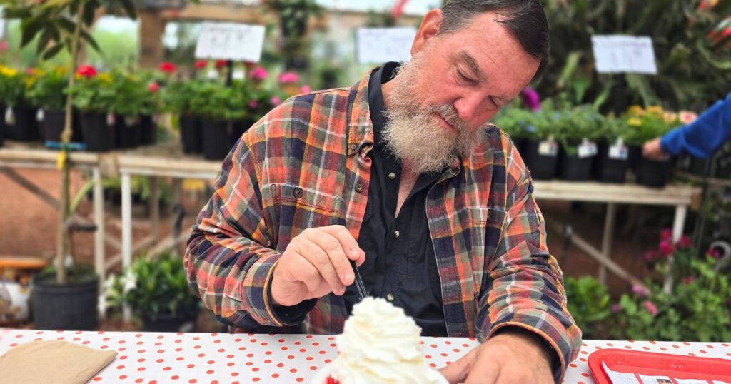 THIS IS AN IMAGE OF A MAN EATING STRAWBERRY SHORTCAKE AT PARKDALE FARM MARKET