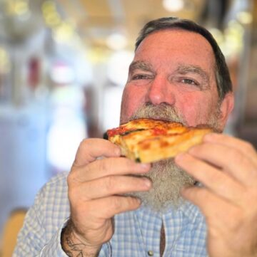 ST. AUGUSTINE FOOD CRAWL THIS IS AN IMAGE OF A MAN EATING PIZZA