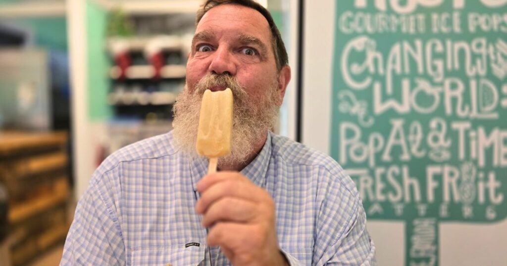 THIS IS AN IMAGE OF A MAN EATING A POPSICLE AT THE HYPPO