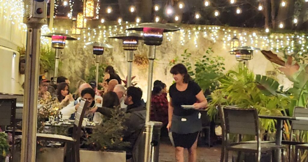 THIS IS AN IMAGE OF OUTSIDE DINING AT NIGHT WITH CAFE LIGHTS AT CATCH 27