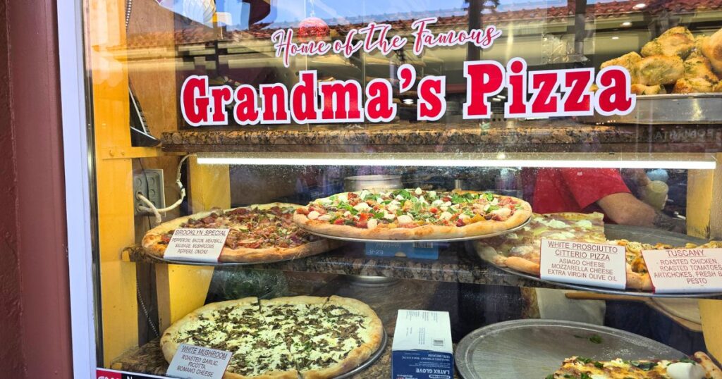 THIS IS AN IMAGE OF PIZZAS IN THE WINDOW OF PIZZA TIME IN ST. AUGUSTINE