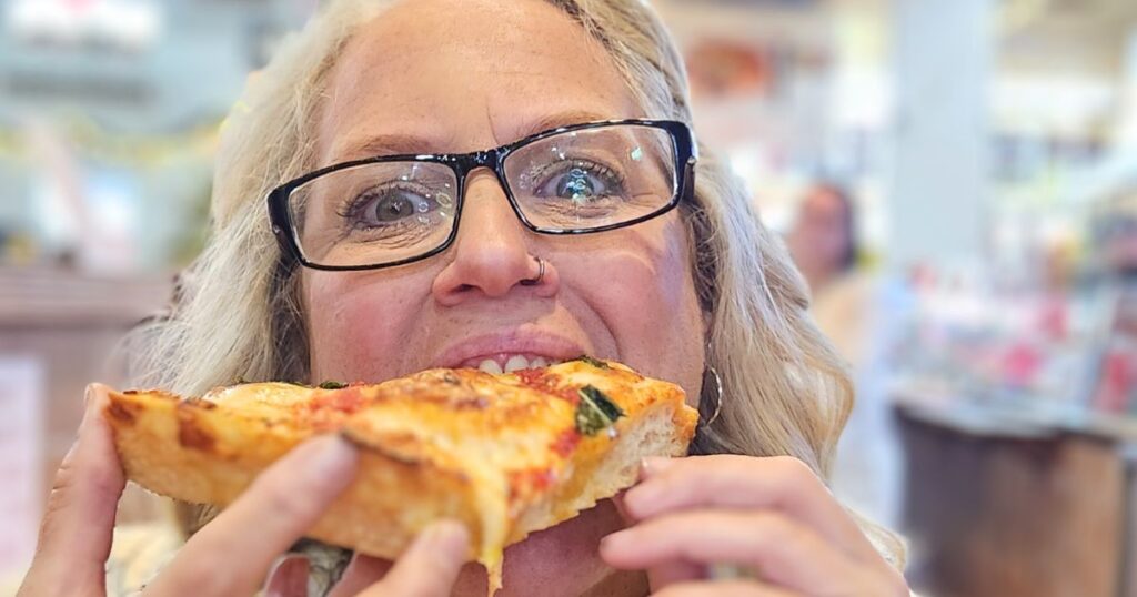 ST. AUGUSTINE FOOD CRAWL THIS IS AN IMAGE OF A WOMAN EATING PIZZA