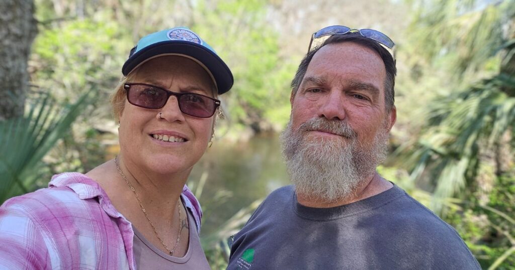 THIS IS AN IMAGE OF A COUPLE OUTHIKING AT HILLSBOROUGH RIVER STATE PARK