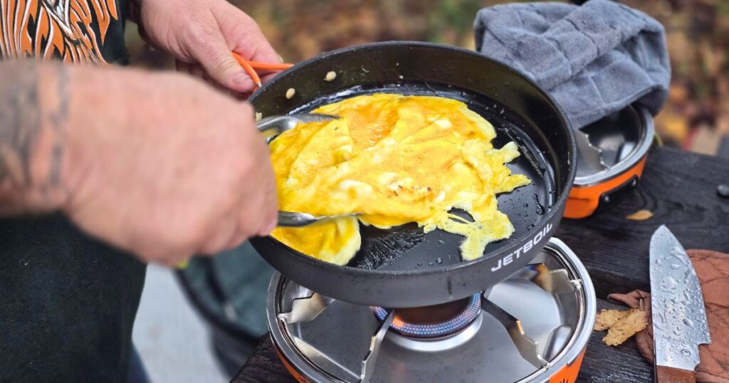 THIS IS AN IMAGE OF EGGS COOKING IN THE JETBOIL GENESIS BASECAMP PORTABLE CAMPING STOVE