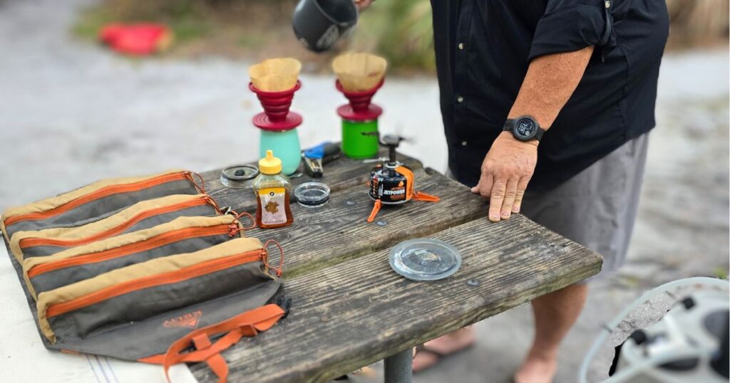 THE BEST PORTABLE CAMPING STOVES THIS IS AN IMAGE OF A MAN MAKING COFFEE WITH THE JETBOIL STASH